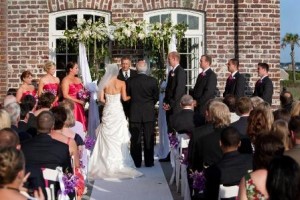 Outdoor wedding ceremony with guests and bridal party.