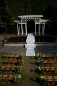 Outdoor wedding venue with white aisle.