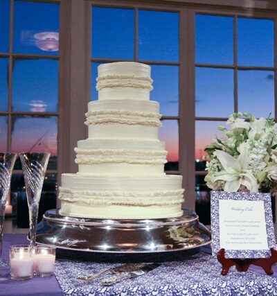 Wedding cake on table with sunset background.