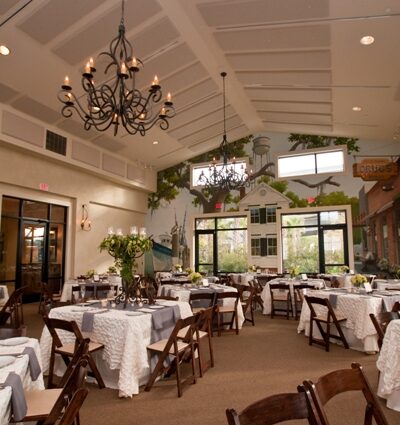 Elegant banquet hall with decorated tables.