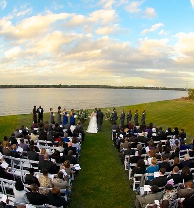 Outdoor wedding ceremony by a lake.
