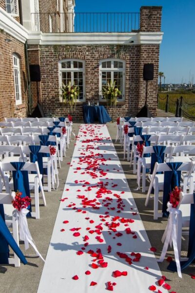 Outdoor wedding setup with aisle and chairs.