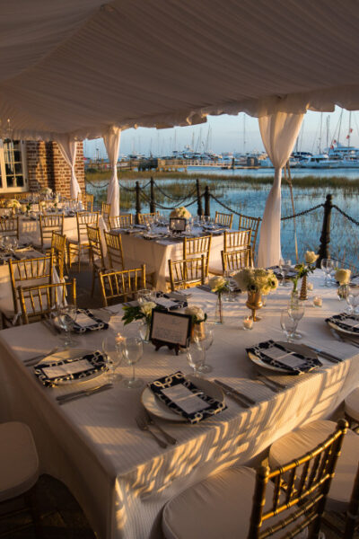 Elegant outdoor dining setup by the waterfront.