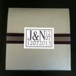 Wedding invitation with initials and date.
