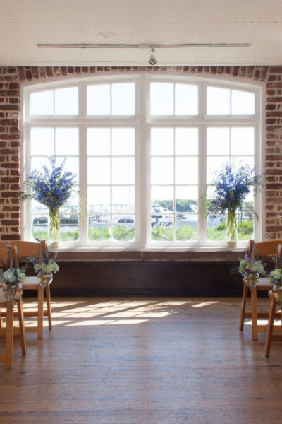 Indoor wedding ceremony with floral decorations.