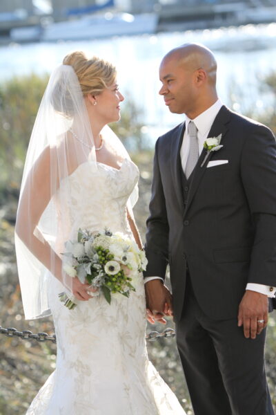 Bride and groom gazing at each other during outdoor wedding ceremony.