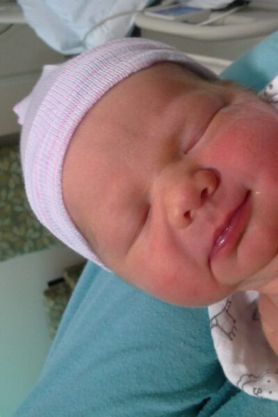 Sleeping newborn baby in a hospital room.