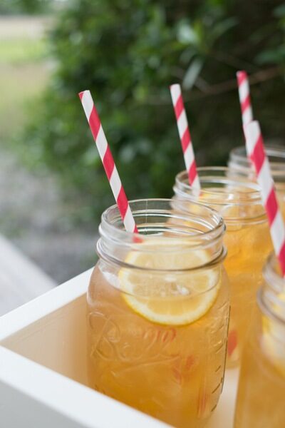 Refreshing iced lemon tea served in mason jars with striped straws.