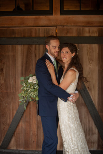 A couple embraces lovingly at their wedding ceremony.