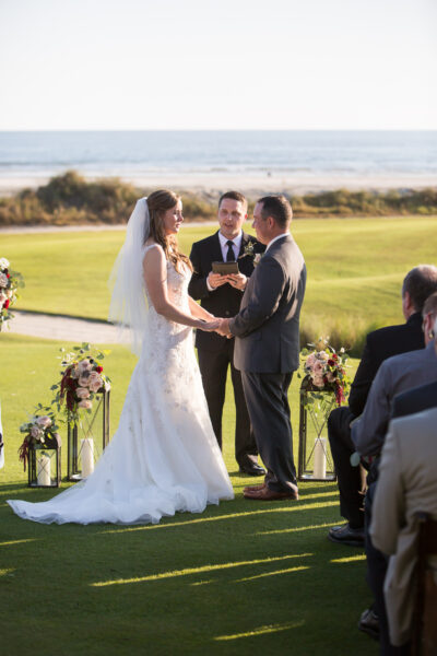 A couple exchanging vows outdoors in a beautiful wedding ceremony.