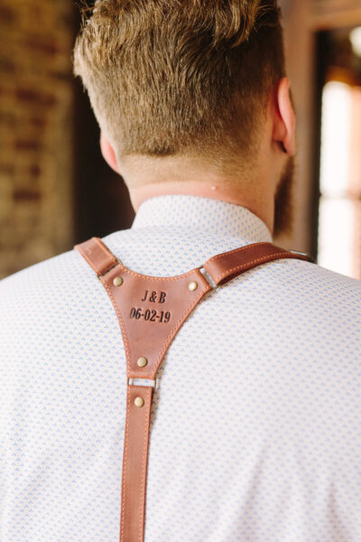 Man wearing a leather shoulder holster labeled 'JOB HUNT'.