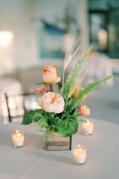 Elegant floral centerpiece with roses and greenery.
