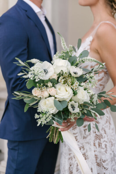 Elegant bridal bouquet with white flowers and greenery.