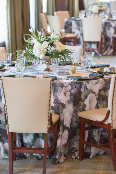 Elegant dining table with floral centerpiece and soft lighting.
