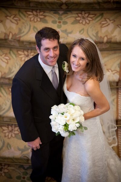 A happy bride and groom smiling at their wedding.