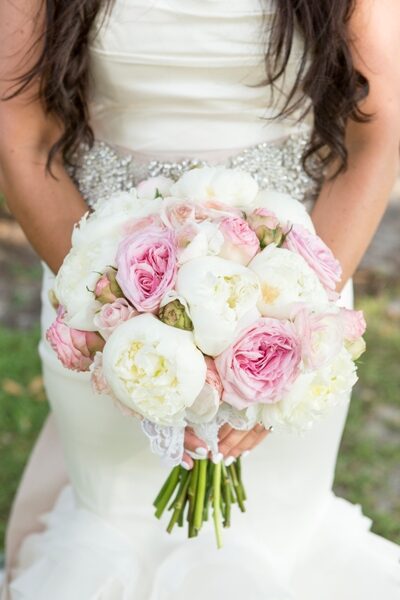 Bride holding a bouquet of pink and white flowers.