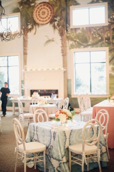 Elegant dining room with round tables and floral centerpieces.