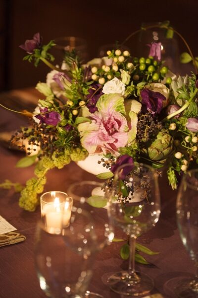 Elegant floral centerpiece with soft pink blooms and candlelight ambiance.