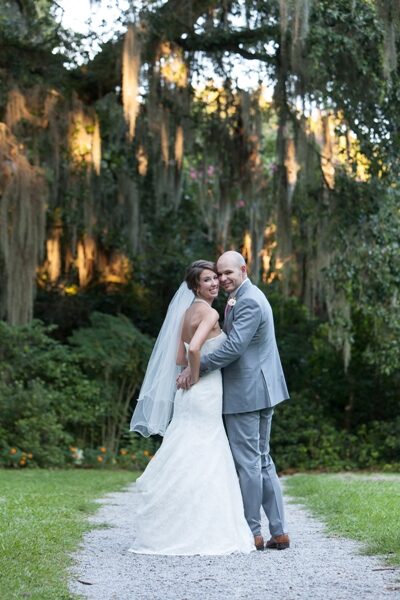 Bride and groom smiling during outdoor wedding.