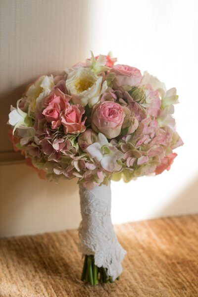 A delicate bouquet of pink and white flowers in soft lighting.