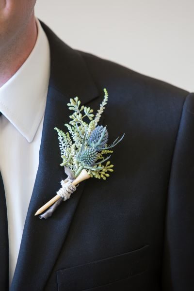 Elegant boutonniere pinned on a black suit jacket.
