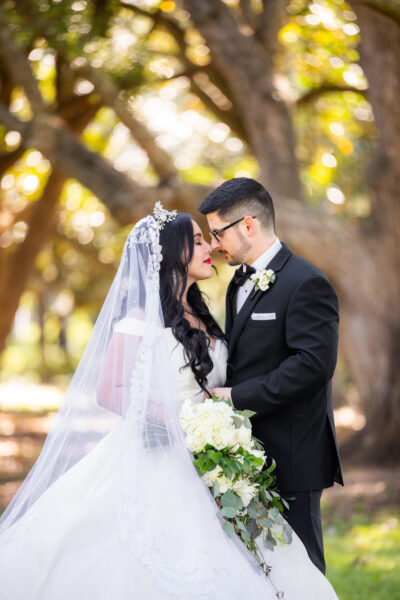 Bride and groom sharing an intimate moment outdoors.