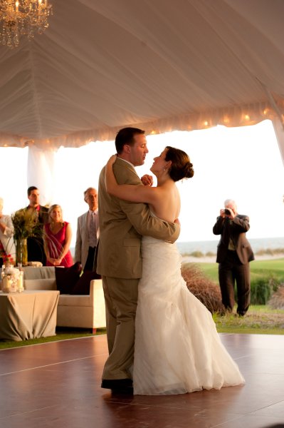 A bride and groom share their first dance at a wedding reception.