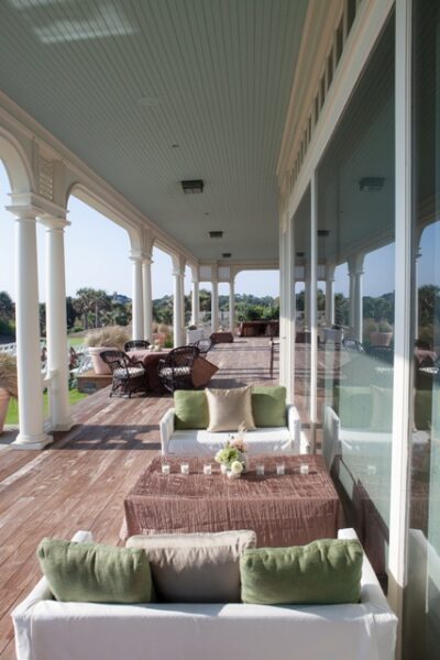 Spacious veranda with wicker furniture and scenic views.