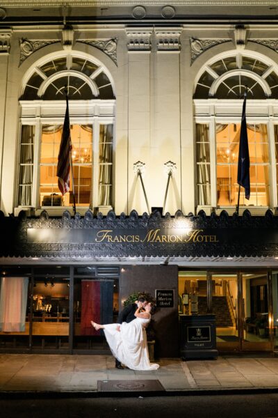A person stands in front of the elegant France Inter building at night.