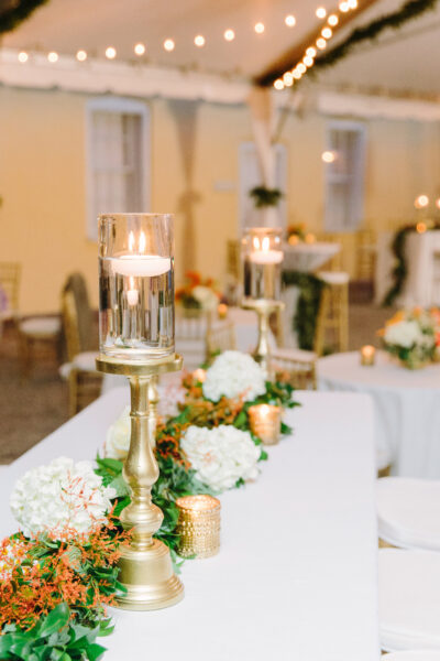 Elegant candles and floral centerpiece on a wedding table.