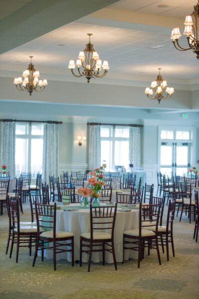 Elegant banquet room with round tables and floral centerpieces.