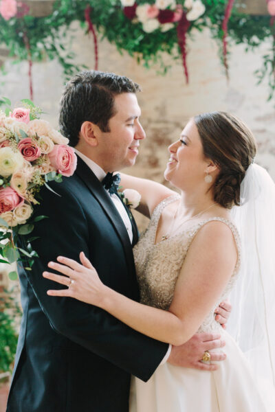 Bride and groom sharing a joyful moment on their wedding day.
