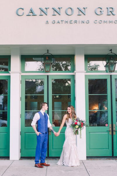 Bride and groom holding hands outside Cannon Green restaurant.