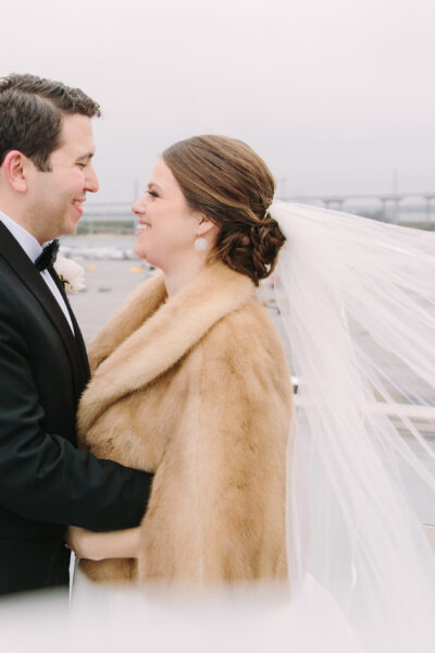 Bride and groom share a loving moment outdoors on their wedding day.