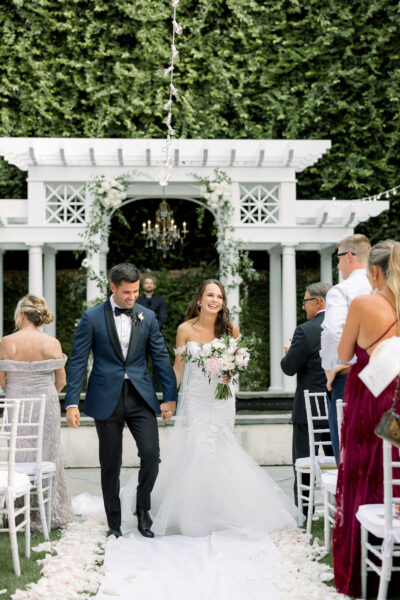 Newlywed couple walking down the aisle after their wedding ceremony.