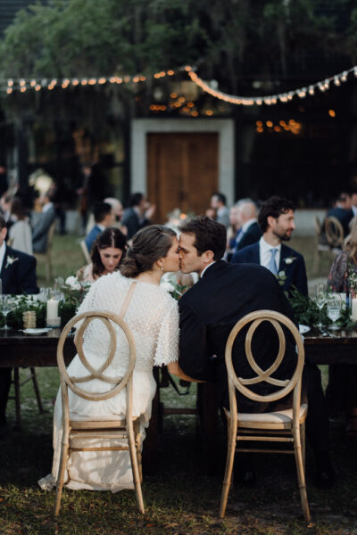 Couple sharing a tender moment at a wedding reception.