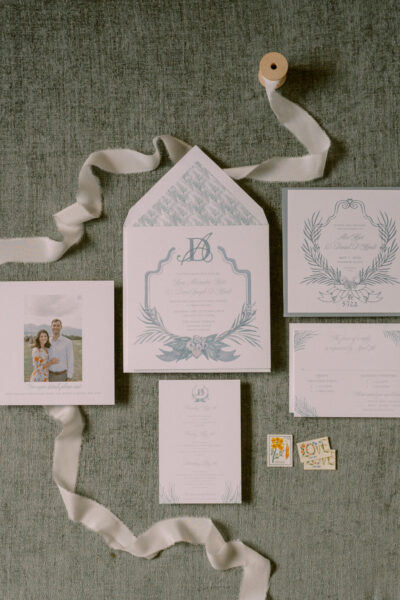Elegant wedding invitation suite with floral accents and soft ribbon.