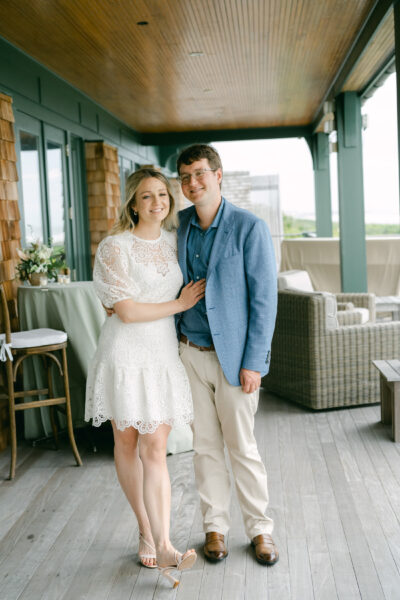Couple posing together on a porch with natural light.