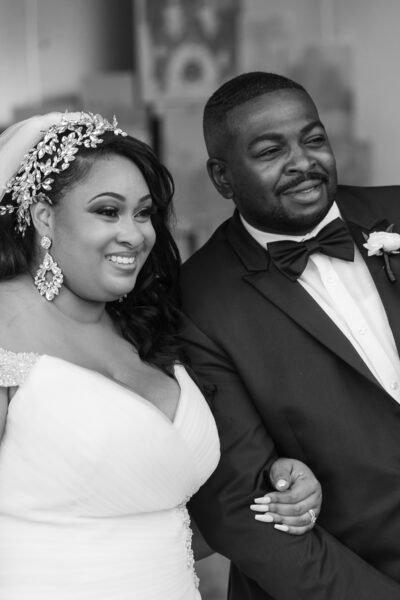 Smiling bride and groom posing together on their wedding day.
