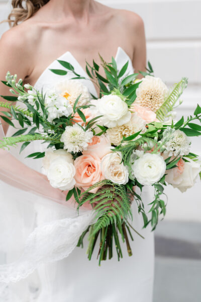 Elegant bridal bouquet with white and soft peach flowers.