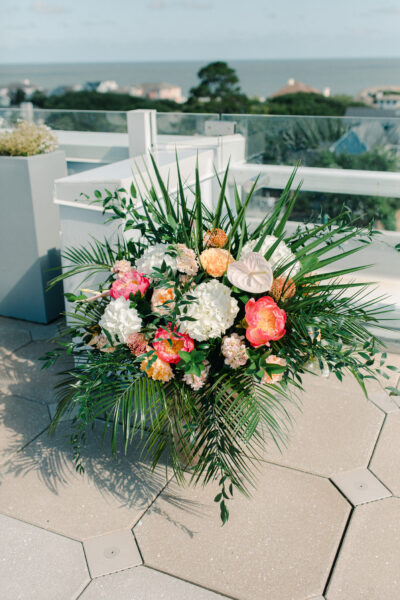 A vibrant bouquet with assorted colorful flowers and lush greenery.