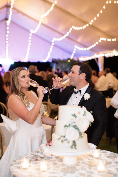 Bride and groom feeding each other cake at their wedding reception.