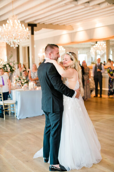 A bride and groom share their first dance at a wedding reception.