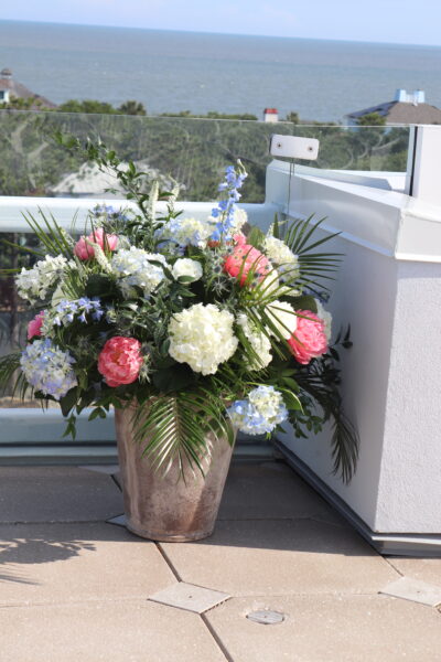 Elegant flower arrangement with pink, white, and blue blooms in a vase.