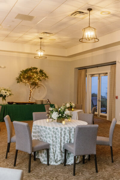 Elegant dining room with floral centerpieces and soft lighting.