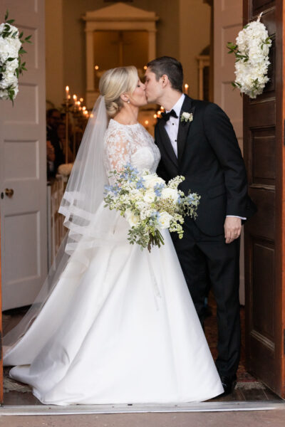 Bride and groom share a kiss on their wedding day.