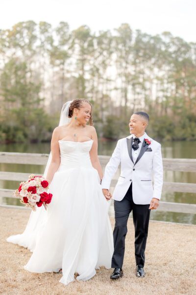 Bride and groom holding hands outdoors on their wedding day.
