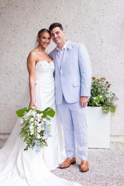 A bride and groom posing together on their wedding day.